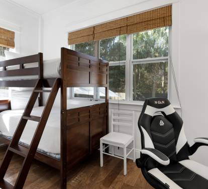 Your perfect space combines comfort and fun with cozy bunk beds and a gaming chair ready for your next adventure.