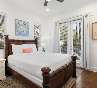 Your coastal bedroom retreat features a charming four-poster bed with crisp white linens and ocean-themed touches.