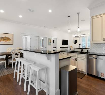 Your gourmet kitchen features pristine countertops, modern appliances, and a welcoming breakfast bar where you'll enjoy morning coffee.