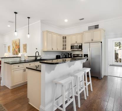 Your fully equipped kitchen invites culinary adventures with granite counters, stainless appliances, and a breakfast bar perfect for morning coffee.