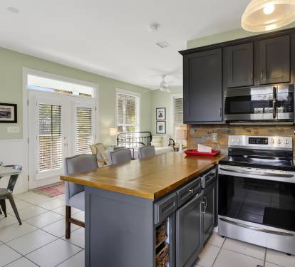Cook memorable meals in your spacious kitchen with stainless appliances, wood countertops, and natural light streaming through French doors.