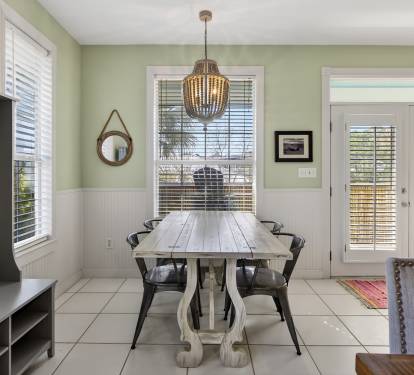 Gather around your elegant dining table under the warm chandelier glow, perfect for memorable meals and conversations.