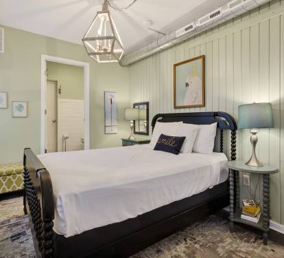 Unwind in your charming bedroom with crisp linens, warm lighting, and coastal cottage vibes that invite peaceful rest.