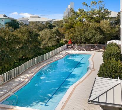 Sparkling blue pool surrounded by lush greenery, perfect for your morning swim or afternoon relaxation.