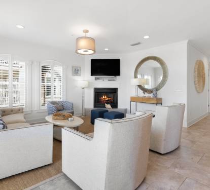 Sink into plush seating around the crackling fireplace while your favorite shows play on the mounted TV—pure comfort awaits.