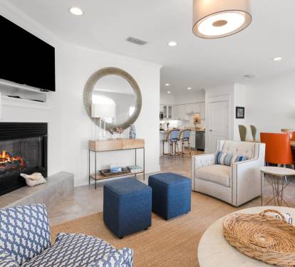 Unwind in your bright, modern living space with cozy fireplace, stylish furnishings, and open kitchen—perfect for relaxing evenings.