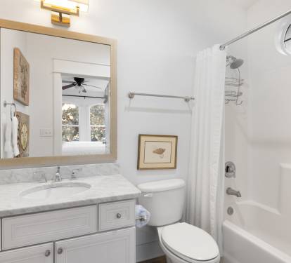 Your pristine bathroom awaits with marble countertops, plush towels, and a relaxing tub-shower combo perfect for unwinding after your adventures.