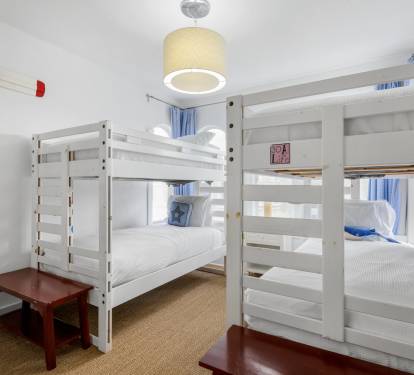 Cozy bunk room with fresh linens and nautical touches - perfect for kids or groups sharing adventures together.