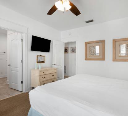 Your serene bedroom sanctuary features crisp white linens, warm coastal touches, and all the comforts you need for restful nights.