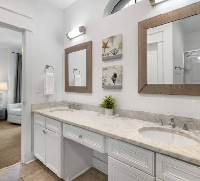 Refresh in your elegant ensuite with dual vanities, marble countertops, and coastal charm—perfectly connected to your peaceful bedroom retreat.