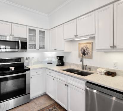 Your bright, fully-equipped kitchen awaits with granite counters, stainless appliances, and everything you need to prepare meals during your stay.