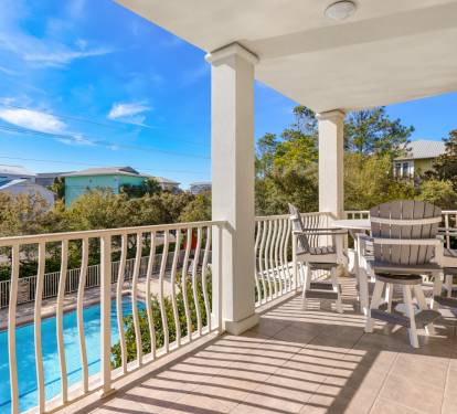 Relax on your private balcony overlooking the sparkling pool, where comfortable seating awaits your morning coffee or evening unwind.