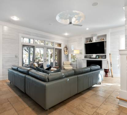 Unwind in your spacious living room with plush leather seating and cozy fireplace, perfect for relaxing after exploring.