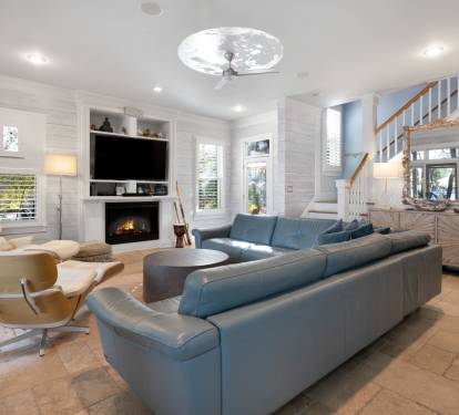 Unwind in this elegant living room where plush seating surrounds a cozy fireplace, perfect for relaxing evenings together.