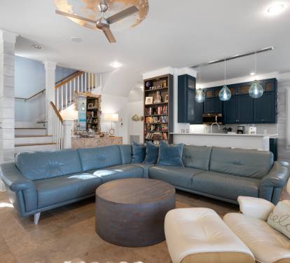 Sink into plush leather seating in your spacious open-concept living area, where coastal blues and warm wood create the perfect retreat.