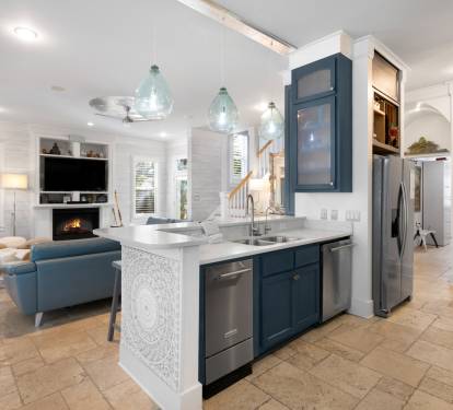 Gather in your stunning open-plan space where coastal blues meet warm whites, creating the perfect backdrop for memorable meals and relaxed evenings.