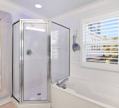 Unwind in your elegant master bathroom with a luxurious soaking tub and separate glass shower.