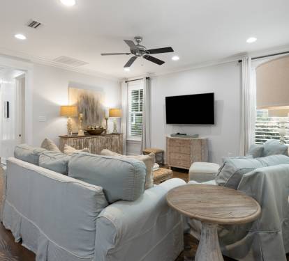 Relax in your elegant living space with plush seating, warm lighting, and coastal-inspired décor creating the perfect atmosphere for unwinding.