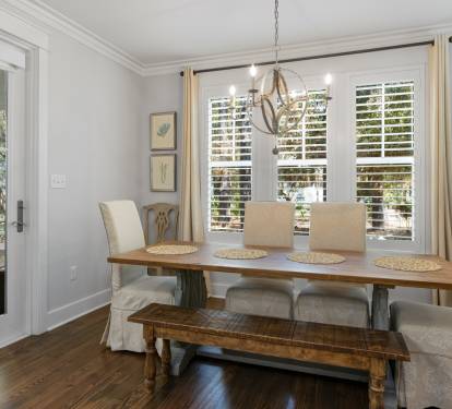 Gather around your elegant dining table where morning coffee and evening conversations flow naturally in this beautifully appointed space.