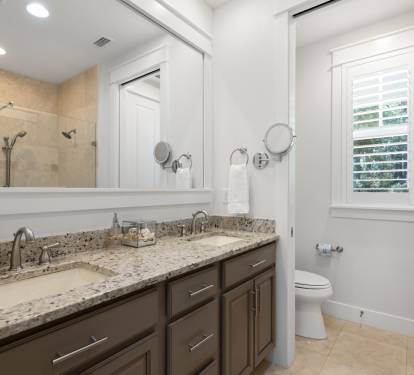 Enjoy this elegant bathroom with granite counters, dual sinks, and walk-in shower - your private spa-like retreat.