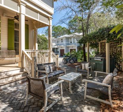 Relax in your private courtyard oasis with comfortable seating and lush greenery creating the perfect outdoor retreat.