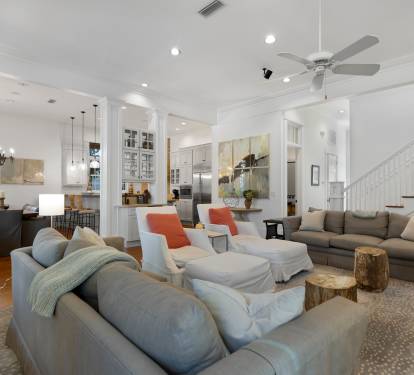 Sink into plush sofas in your spacious living room, where natural light streams through windows and cozy seating invites relaxation.