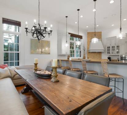 Gather around this rustic dining table while your chef creates magic in the open kitchen. Natural light streams through tall windows.