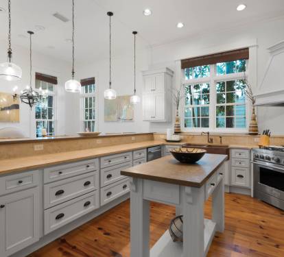 Your spacious kitchen invites culinary adventures with gleaming countertops, modern appliances, and warm natural light streaming through charming windows.