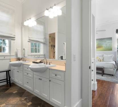 Pamper yourself in this elegantly appointed bathroom with dual vanities, modern lighting, and peaceful bedroom views.