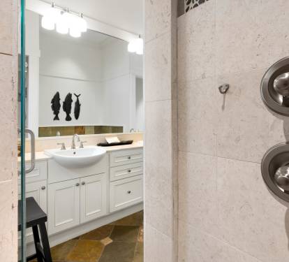 Step into your private spa-like shower with elegant marble walls and modern fixtures, creating the perfect space to refresh after your adventures.