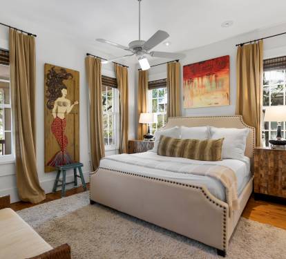 Sink into your elegant bedroom sanctuary with plush linens, warm lighting, and charming artwork creating the perfect retreat after exploring.
