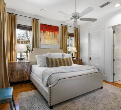 Sink into your comfortable bed surrounded by warm colors, soft lighting, and thoughtful touches that make this space feel like home.