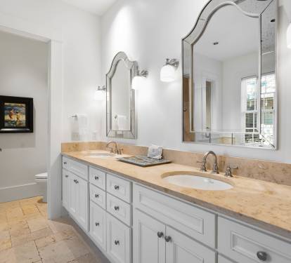 Pamper yourself at this elegant double vanity with marble countertops, perfect lighting, and spa-like amenities for your morning routine.