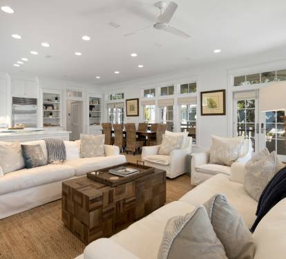 Sink into plush white sofas in your open-concept haven, where kitchen and living flow seamlessly together for perfect entertaining.