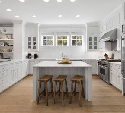 Your bright, fully equipped kitchen invites culinary adventures with stainless steel appliances, spacious island, and warm wood accents creating the perfect gathering spot.