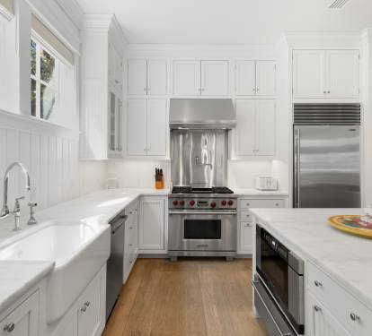 This bright kitchen welcomes you with crisp white cabinets, premium appliances, and plenty of counter space for your culinary adventures.