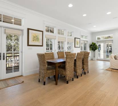 Gather around this stunning dining table where natural wicker chairs invite memorable meals together in bright, airy elegance.