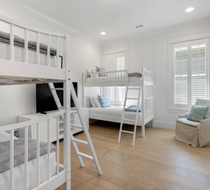 Sleep soundly in this bright bunk room featuring comfortable beds and cozy seating for your family's perfect rest.