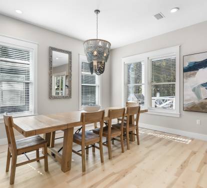Your elegant dining space features a warm wood table for six under a stunning chandelier, perfect for memorable meals together.