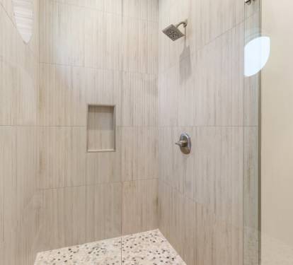 Step into your private oasis with elegant tiled walls and a refreshing rainfall shower to wash away the day.