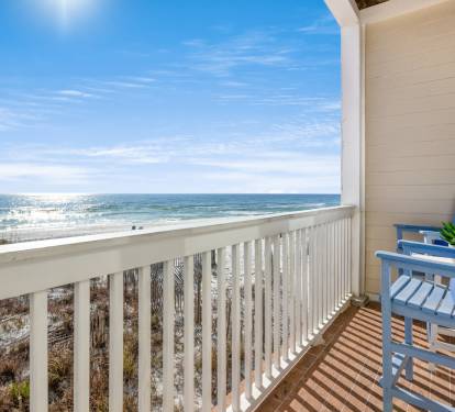 Wake up to endless gulf views from your private balcony, where blue Adirondack chairs invite morning coffee moments and sunset relaxation.
