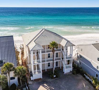 Gulf front vacation rental with direct beach access and stunning turquoise waters just steps from the property.