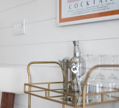 Craft cocktails await on your stylish bar cart, complete with premium glassware and cocktail shaker for memorable evenings.