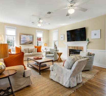 Unwind in your cozy living room with plush seating, warm fireplace, and entertainment center for perfect relaxation.