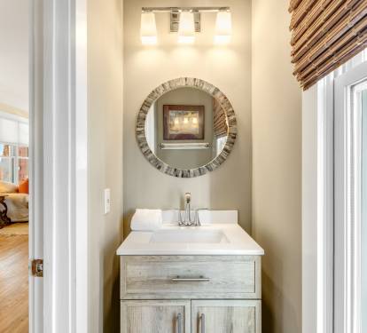 Step into your private powder room featuring elegant vanity, stylish mirror, and warm natural lighting for your daily rituals.