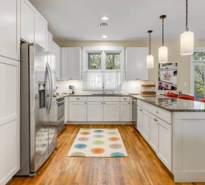Cook your favorite meals in this bright, fully-equipped kitchen with granite countertops and modern appliances.
