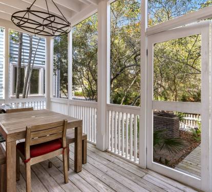 Unwind on your private screened porch, where natural light streams through panoramic windows framing lush treetop views.