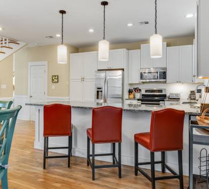 Gather around the spacious kitchen island where meals become memories, featuring gleaming granite counters and stylish pendant lighting for your culinary adventures.