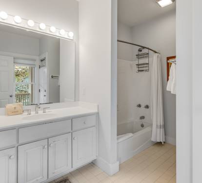 Your bright bathroom features a spacious vanity with Hollywood-style lighting, perfect for getting ready each morning.