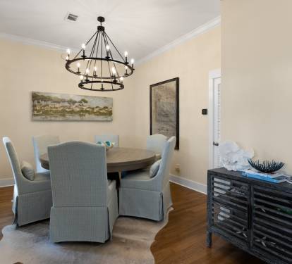 Gather around your elegant dining table beneath the stunning chandelier for memorable meals together.